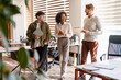 © Maria Vitkovska - Diverse business team collaborating in shared modern office