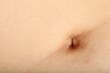 © New Africa - Closeup view of normal skin with belly button