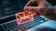 © Oji - Cybersecurity phishing attack concept glowing envelope on fishing hook above laptop keyboard