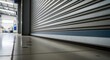 © Bakha - Roller shutter door closing in warehouse interior with reflective floor surface