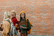 © La Famiglia - Happy young university students walking together on campus