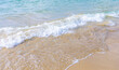 © SeNata - Gentle ocean waves lapping against sandy beach shoreline in sunlight