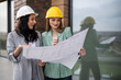 © Zoran Jesic - Women architects on site discussing building plans
