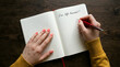 © Gambar - woman writing in notebook with life goals