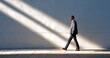 © perfectlab - Businessman walking confidently along a sunlit urban wall with strong diagonal shadows and minimalist background in daytime