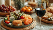 © Jhati - Appetizer plate with cheese olives cherry tomatoes crackers a glass of red wine