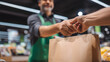 © Jackpot - Close Up of Grocery Store Worker Passing Shopping Bag to Customer