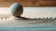 © e_zeynall1 - A stone pebble rests perfectly balanced atop a small mound of sand, surrounded by rhythmic ripples, creating a serene and mindful scene of tranquil contemplation and inner peace.