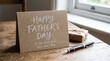 © Amina - Happy Father's Day card with gift and pen on wooden table