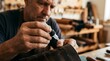 © Wool World - Craftsman Applying Glue to Leather in Workshop Close-Up, Handmade Craftsmanship, Indoor Environment, Focused View