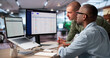 © Andrey Popov - Procurement Manager And Colleague Discuss Software Platform