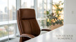 © high quality design  - A luxurious leather executive chair sits at a modern office desk, overlooking a city skyline bathed in golden hour light, suggesting a sophisticated and productive workspace.