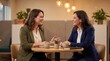 © Nadia - Two Professional Women Having Coffee Meeting in Modern Office Lounge