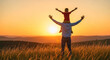 © PhotoArtHub - Silhouetted man carrying a boy on shoulders with arms raised against a golden sunset, symbolizing family joy and outdoor adventure