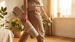 © Omishu Makes - Woman in comfortable loungewear carrying rolled yoga mat at home wellness lifestyle concept