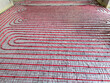 © New Africa - Installation of underfloor heating system in building, above view