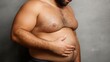 © Olivia - Man touching fat belly on grey background, obesity and overweight concept with abdominal body fat, unhealthy lifestyle, weight gain, healthcare awareness and fitness motivation