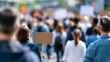 © Laura - Group of people protesting on a city road in broad daylight, public demonstration and civic rights concept, social movement, diverse crowd, defocused urban background, faceless,