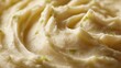 © fivan - A macro shot of buttery mashed potatoes blended with leeks, showing smooth texture and light reflections on a neutral background