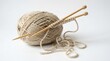 © HabiburRahman - Natural beige yarn ball with wooden knitting needles on clean for crafting isolated on white background