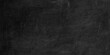 © Vectlis Arts - Black chalkboard texture background with subtle chalk dust streaks and smudges for copy space. Textured dark gray to black chalkboard or slate surface.