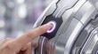 © Xos Contributor  - Finger pressing futuristic button on metallic panel with glowing purple light
