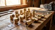© mrrnill - Arrangement of various golden brass pipe fittings and valves placed on rough wooden workshop table with wrenches and heavy industrial metal vice in background area.