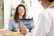 © Studio Marmellata - A dentist reviews a dental x-ray with a smiling patient, discussing treatment options in a modern clinic setting.