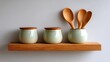 © buraratn - Elegant wooden shelf with ceramic jars and wooden spoons in a modern kitchen setting, featuring soft pastel colors and minimalist design elements