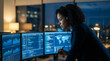 © REAL  - Soft focus blurred photo of Serious woman working late at night on computers with data screens in a dark modern office looking at digital charts and world maps for global business