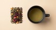 © IqmarRafiq - Cup of herbal tea with dried leaves and flower petals.