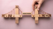 © Dulal - Building a bridge of understanding with wooden blocks and wire, symbolizing connection and communication