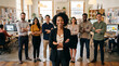 © Rohan Katwe - Diverse creative team standing in modern design studio with confident female creative director, graphic designers, photographers and marketers, collaborative workspace, professional group portrait