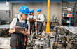 © Westend61 - Factory worker inspecting machinery components using a digital tablet