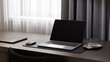 © Westend61 - Blank laptop screen mockup on a dark desk indoors