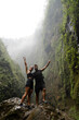 © Westend61 - Happy couple celebrating on rock at Tumpak Sewu Waterfall Java