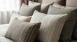© SashaMagic - Cozy bedroom assortment of textured decorative pillows arranged on a bed with soft window light, emphasizing neutral tones and comfort