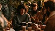 © Justlight - Focused main subject holding a Bible while others pass notebooks around surrounded by coffee mugs and lush houseplants highlighting intimate focus in a warmly lit candid setting.