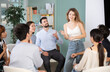 © JackF - Positive young girl talking to attendees of courses sitting in a circle during classes