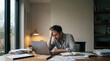 © Abul Kalam Azad - Overwhelmed Man Working Late on Laptop While Managing Bills and Financial Stress at Home
