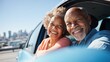 © VictorCanalesStudio - Happy senior african american couple enjoying a road trip together in a car
