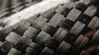© Nuttawut - Carbon Fiber Texture: A close-up, macro view reveals the intricate woven pattern of carbon fiber material, showcasing its unique texture and strength.