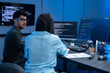 © Art_Photo - Professional IT specialist and programmer working on software development, Male developer talking with female colleague about computer code, Modern coding team and technology collaboration concept