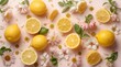 © SleepWorker - Fresh lemons and flowers scattered on a pastel pink surface with green leaves