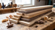 © Yudi - Stack of various hardwood wood planks (oak, walnut) on an old workbench with wood shavings, ready for woodworking