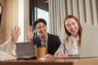 © wichayada - Asian business team waving during virtual meeting in office