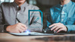 © chaylek - Insurance agent reviewing car insurance documents and digital policy approval with client, supporting automotive coverage, financial protection, contract verification, and claim service.