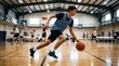 © Viktoriia - Young man playing basketball on indoor court. Athlete dribbling ball during practice session. Competitive sport training and active lifestyle. Team game match in school sport hall.