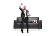 © Ljupco Smokovski - Man in a torn suit holding a football and cheering
