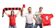 © Ljupco Smokovski - Male and female football fans cheering and holding a red card